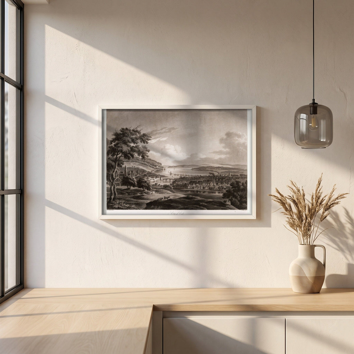 City of Cork by Thomas Sautelle Roberts Art Print framed print in a white frame on a plaster wall above an oak worktop in a bright Scandinavian kitchen