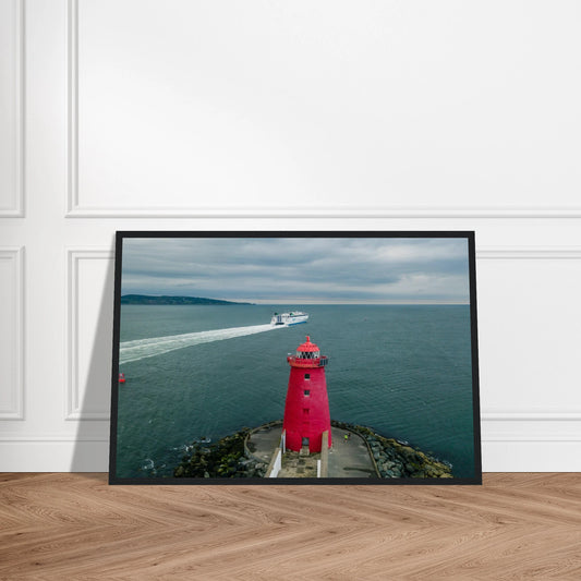 Poolbeg Lighthouse, Dublin Bay photo in a black frame leaning against a panelled wall on a wooden floor