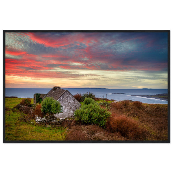 Art print capturing a serene sunset over the Atlantic Ocean in Doolin, Co. Clare, Ireland. A small cottage stands in the foreground, blending with the colorful sky reflecting on the water.