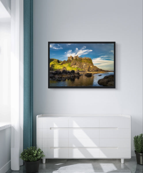 Framed wall art print of Dunluce Castle, showcasing its majestic ruins perched on a rugged cliff overlooking the sea. The detailed image captures the historic architecture and breathtaking coastal scenery, perfect for adding a touch of history and beauty to any room.