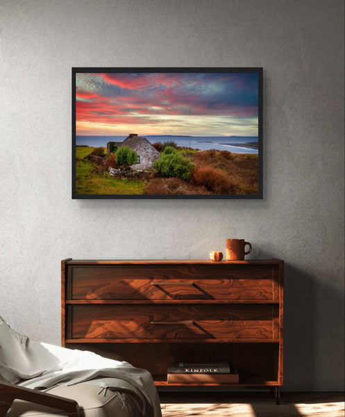 Wall art print of a serene sunset over the Atlantic Ocean in Doolin, Co. Clare, Ireland. Includes a charming cottage amidst coastal scenery, capturing the tranquil beauty of Ireland's west coast.