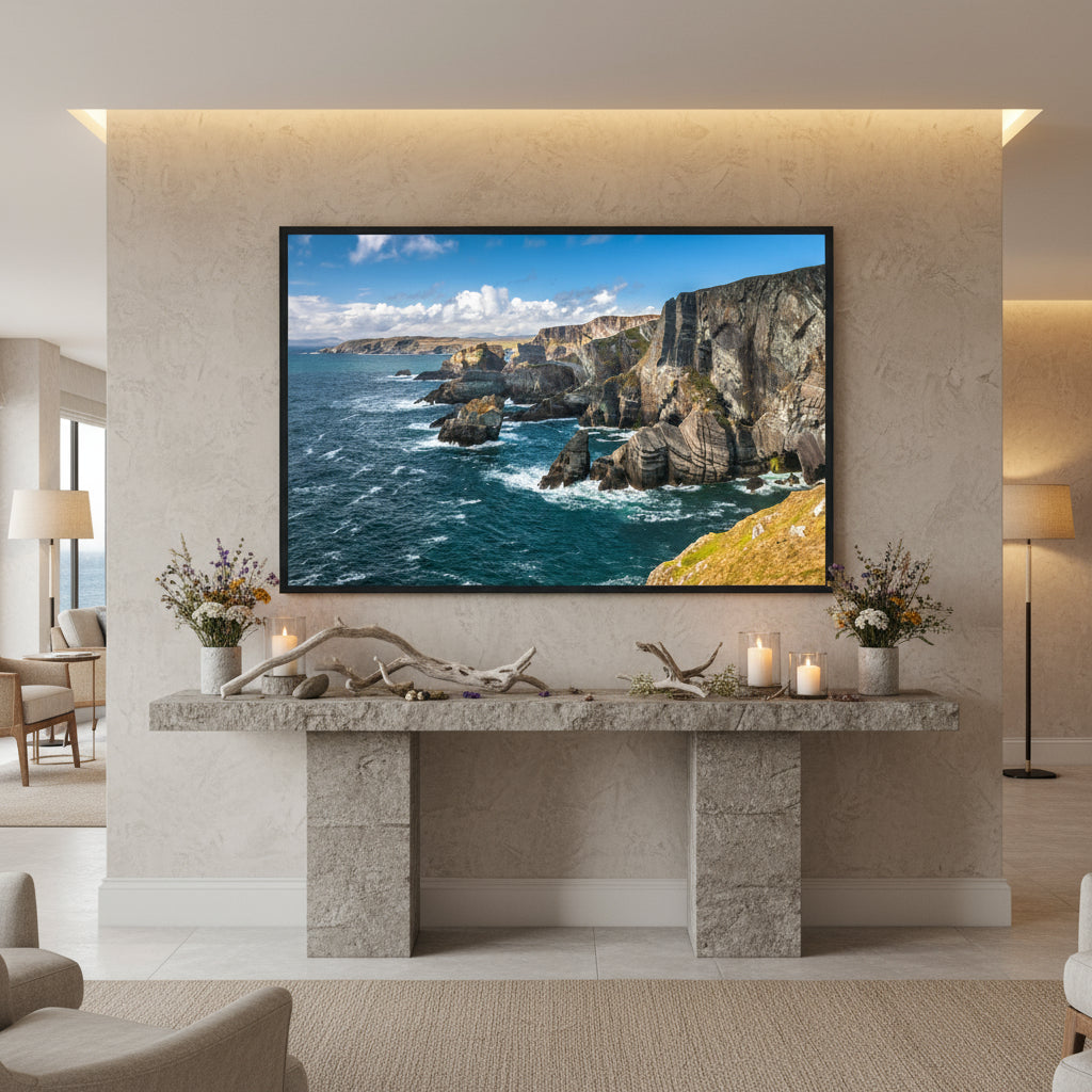 Luxury boutique hotel lobby on the Wild Atlantic Way, Mizen Head framed print over a stone console table with driftwood, candles and Atlantic botanical elements.
