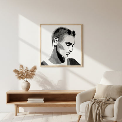 Sinéad O'Connor portrait print in a natural oak frame above an oak bench and cream armchair