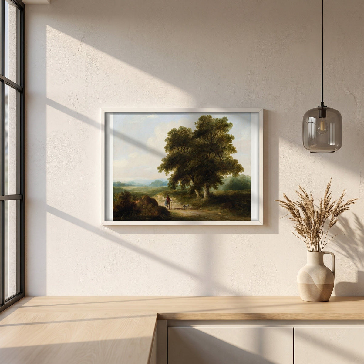 A Landscape, Homeward Bound framed print in a white frame on a plaster wall above an oak worktop in a bright Scandinavian kitchen