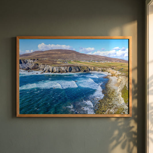Achill Island Framed Print | Wild Atlantic Way, Co. Mayo framed print in a natural oak frame on a dark green wall beside a window, dappled plant shadow