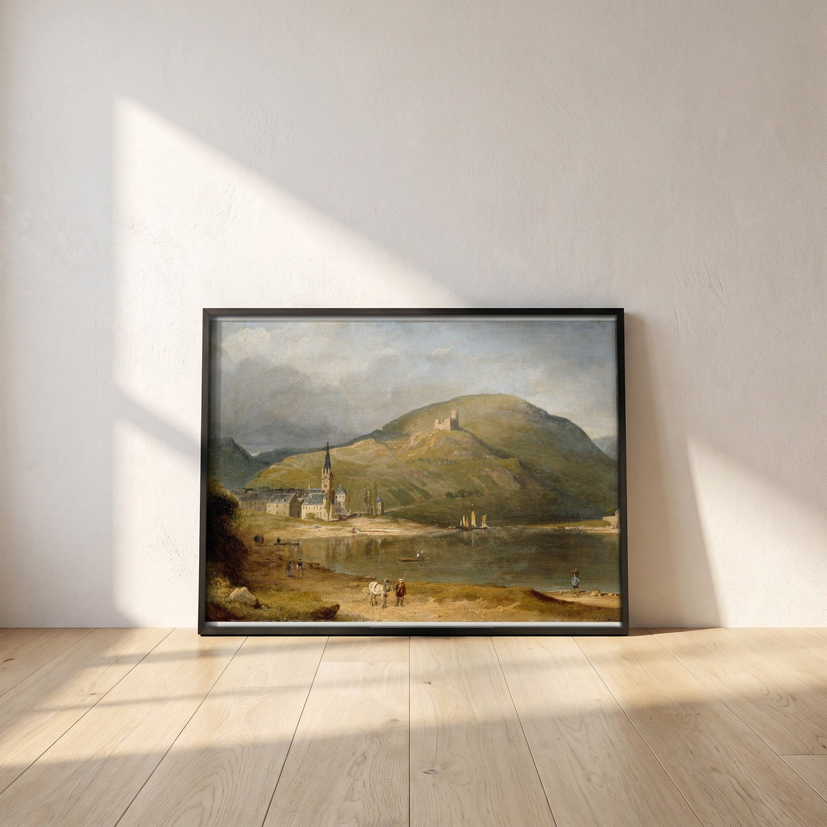 Bernkastel on the Moselle framed print in a black frame leaning against a white plaster wall on oak floorboards in morning light