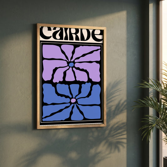Cairde framed print in a natural oak frame on a dark green wall beside a window, dappled plant shadow