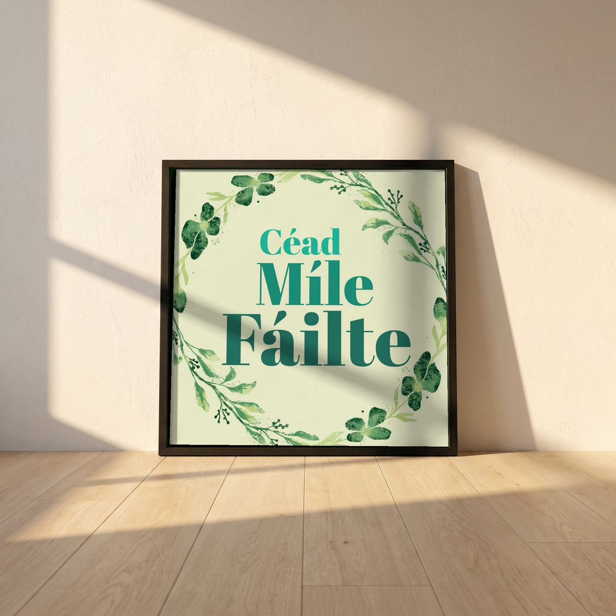 Céad Míle Fáilte framed print in a black frame leaning against a white plaster wall on oak floorboards in morning light