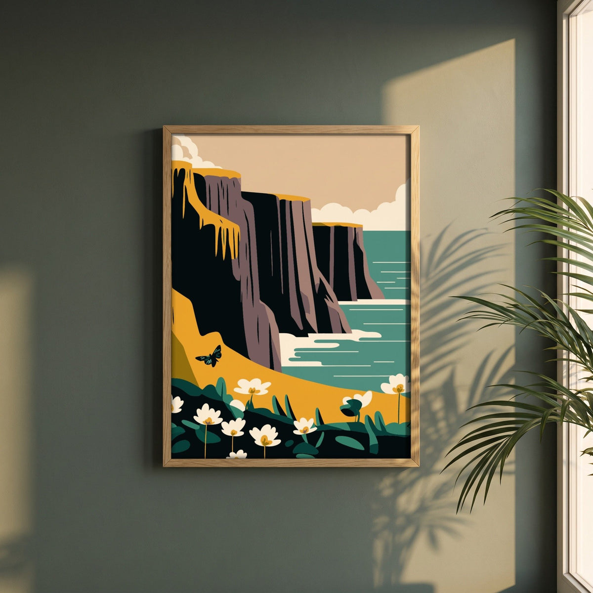 Cliffs of Moher, County Clare framed print in a natural oak frame on a dark green wall beside a window, dappled plant shadow