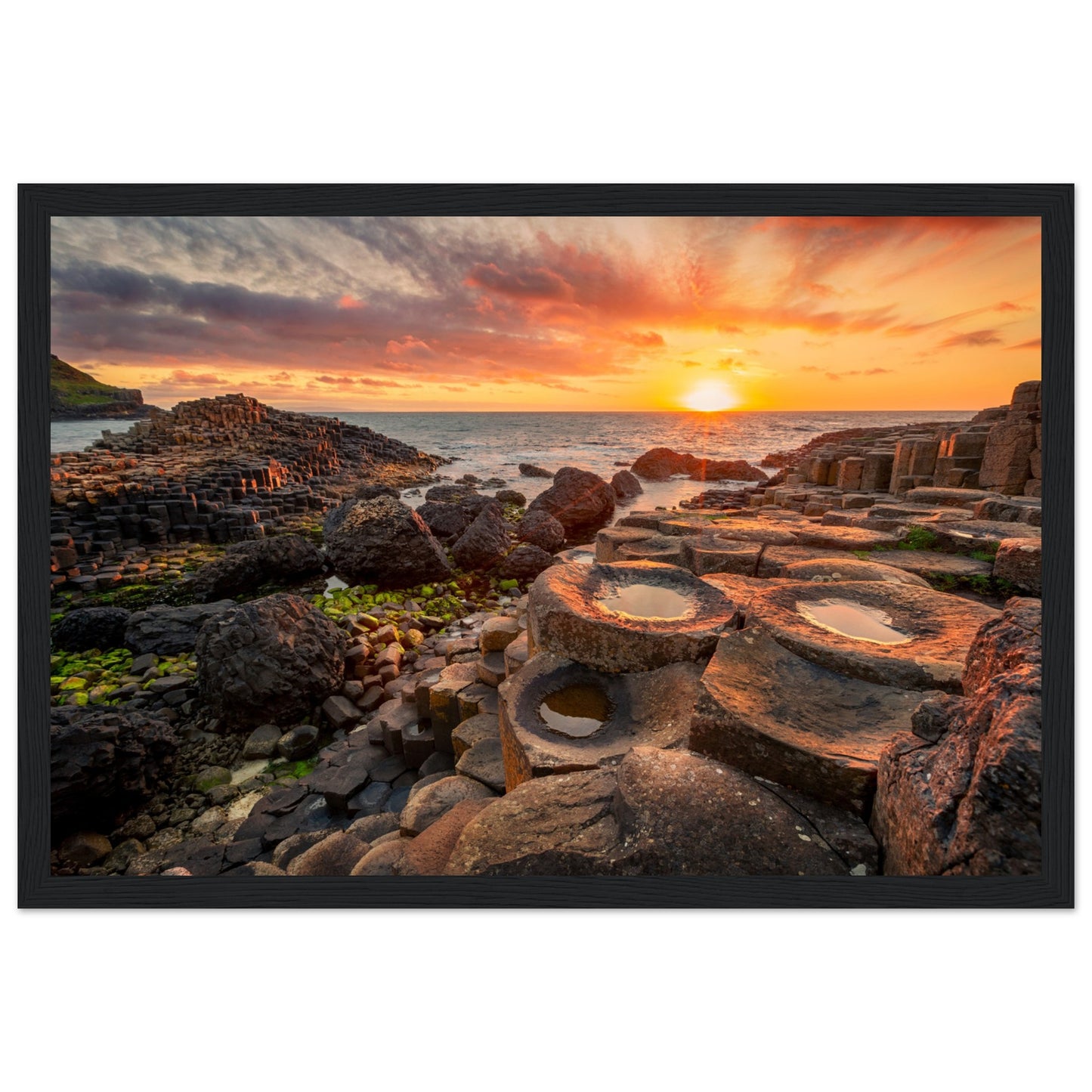 The framed design adds a touch of sophistication, making it a perfect addition to your home or office decor. Immerse yourself in the tranquility of this coastal landscape every day with our Sunset at Giant's Causeway framed art print