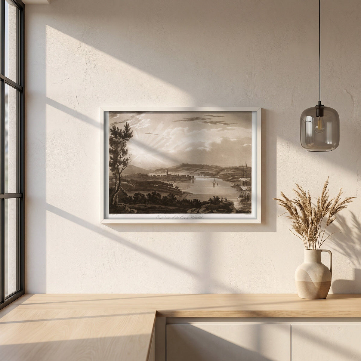 East View of the City of Waterford by Thomas Sautelle Roberts Art Print framed print in a white frame on a plaster wall above an oak worktop in a bright Scandinavian kitchen
