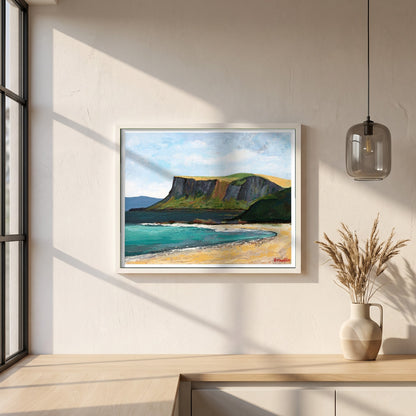 Fair Head from Ballycastle Beach framed print in a white frame on a plaster wall above an oak worktop in a bright Scandinavian kitchen