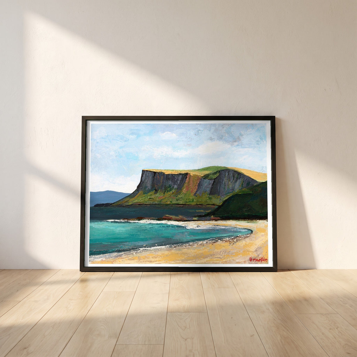 Fair Head from Ballycastle Beach framed print in a black frame leaning against a white plaster wall on oak floorboards in morning light