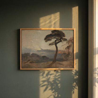 Hampstead Heath, Sunset framed print in a natural oak frame on a dark green wall beside a window, dappled plant shadow