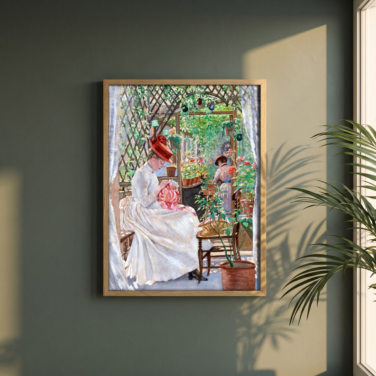 In the Conservatory by Aloysius O'Kelly framed print in a natural oak frame on a dark green wall beside a window, dappled plant shadow
