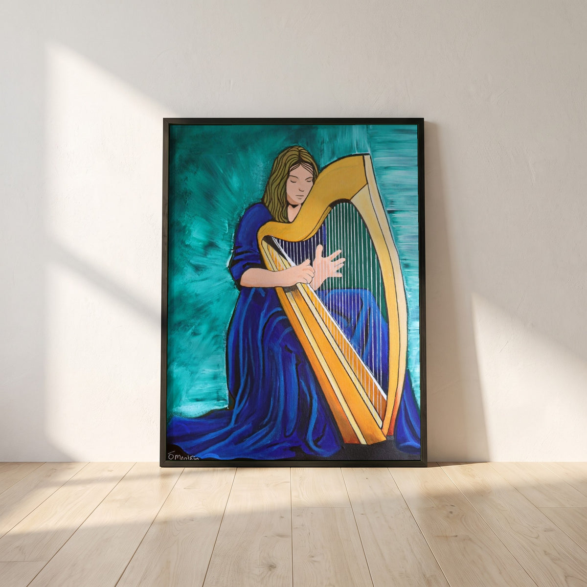 Irish Harp framed print in a black frame leaning against a white plaster wall on oak floorboards in morning light