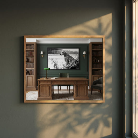 Irish Wolfhound framed print in a natural oak frame on a dark green wall beside a window, dappled plant shadow