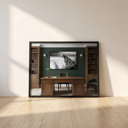 Irish Wolfhound framed print in a black frame leaning against a white plaster wall on oak floorboards in morning light