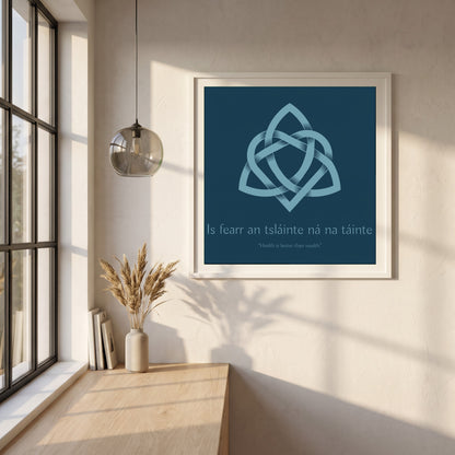 Is fearr an tsláinte ná na táinte framed print in a white frame on a plaster wall above an oak worktop in a bright Scandinavian kitchen