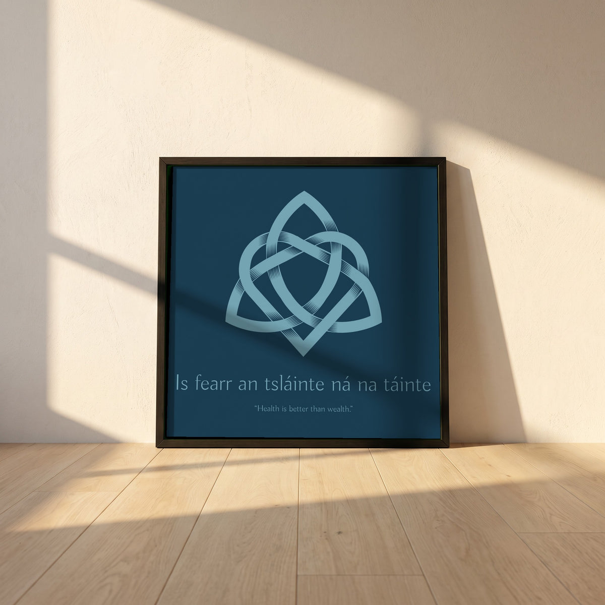 Is fearr an tsláinte ná na táinte framed print in a black frame leaning against a white plaster wall on oak floorboards in morning light