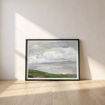 Island Magee framed print in a black frame leaning against a white plaster wall on oak floorboards in morning light