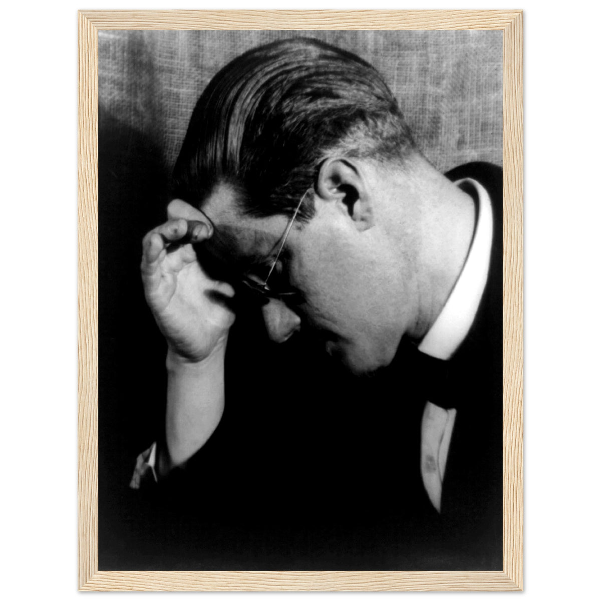James Joyce portrait photo in profile wearing glasses, print in a natural oak frame with white border
