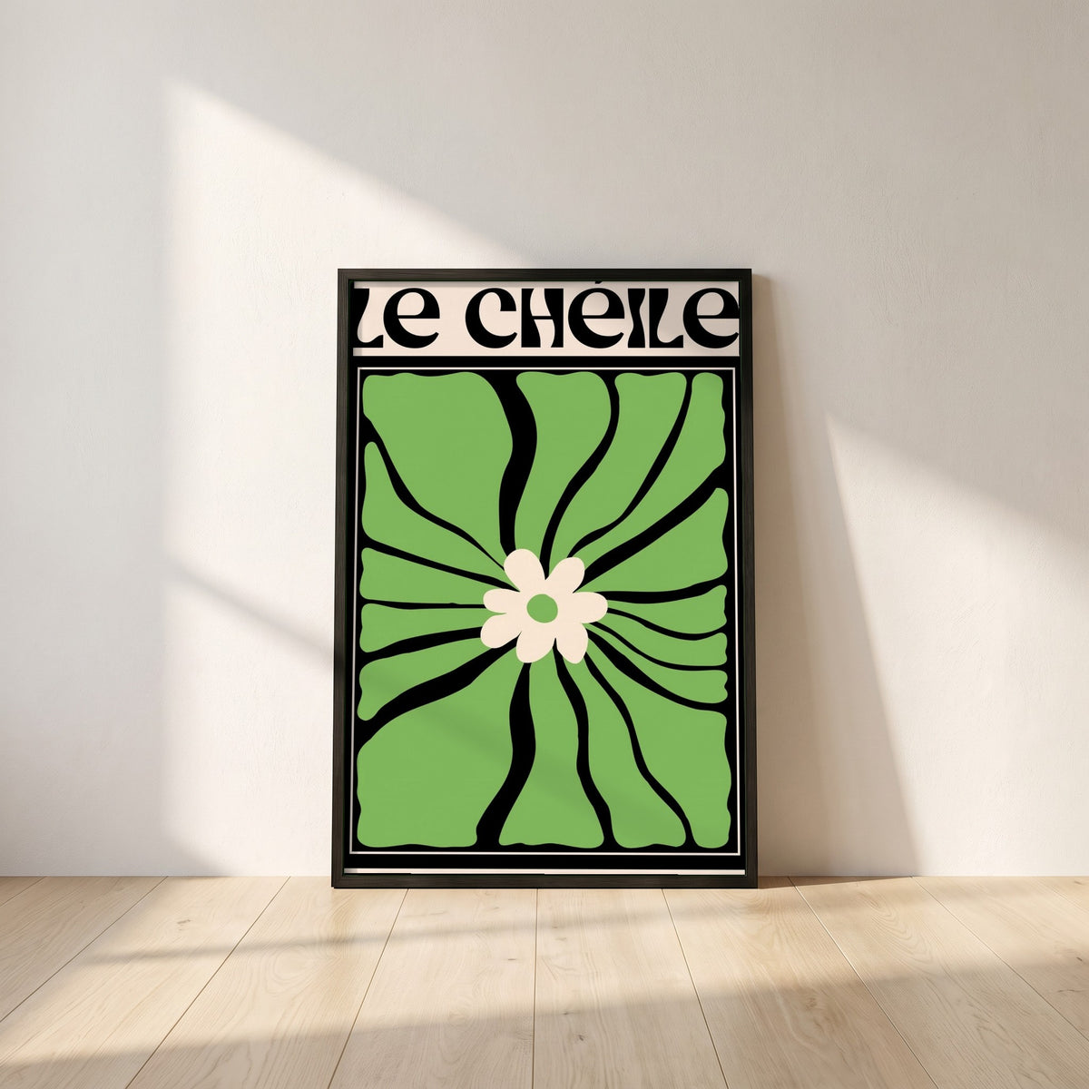 Le Chéile framed print in a black frame leaning against a white plaster wall on oak floorboards in morning light