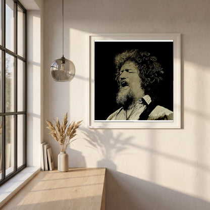Luke Kelly framed print in a white frame on a plaster wall above an oak worktop in a bright Scandinavian kitchen