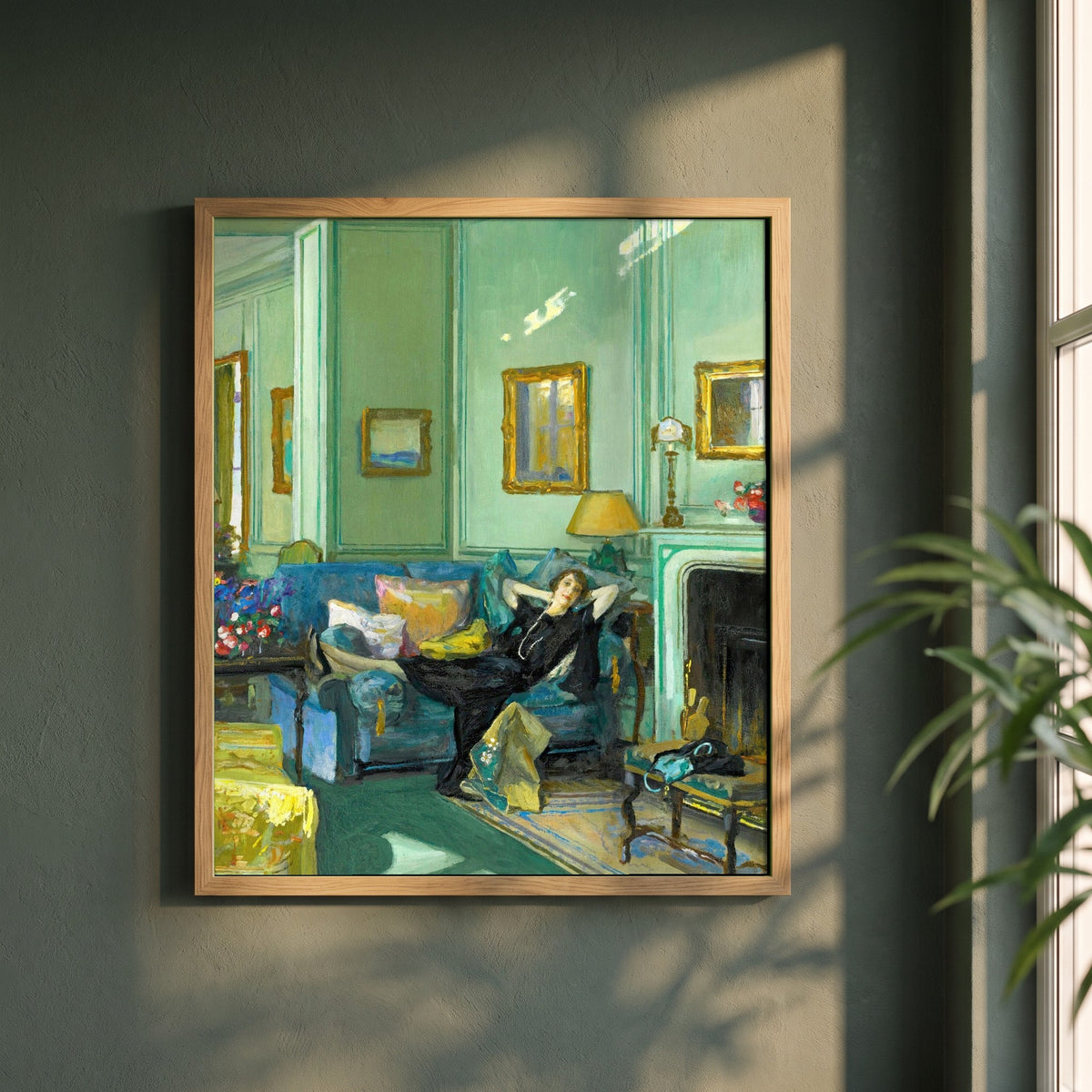 Mrs. Osler framed print in a natural oak frame on a dark green wall beside a window, dappled plant shadow