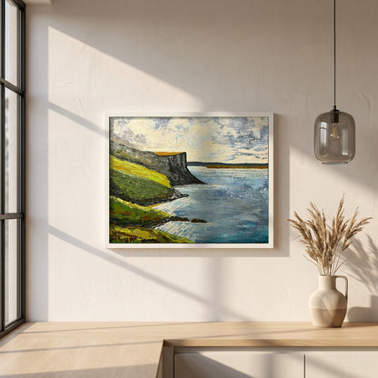 Murlough Bay & Fair Head framed print in a white frame on a plaster wall above an oak worktop in a bright Scandinavian kitchen