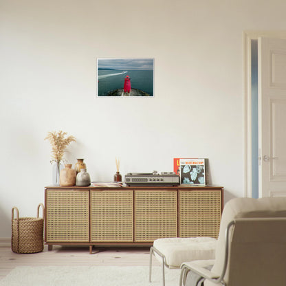Poolbeg Lighthouse, Dublin Bay framed print above a rattan sideboard in a light living room
