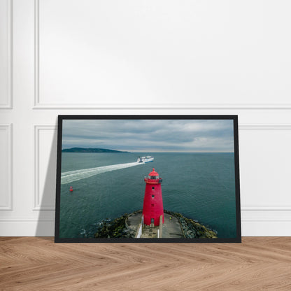 Poolbeg Lighthouse, Dublin Bay photo in a black frame on a wooden floor, straight-on view
