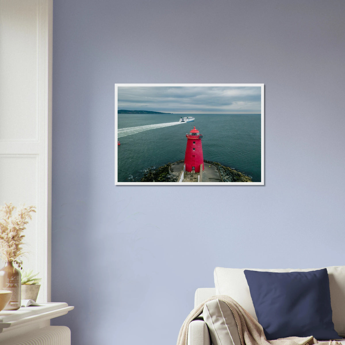 Poolbeg Lighthouse framed photographic print on a lavender wall above a sofa with a navy cushion