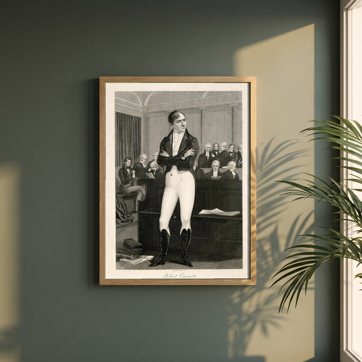 Robert Emmet in Court 1803 framed print in a natural oak frame on a dark green wall beside a window, dappled plant shadow