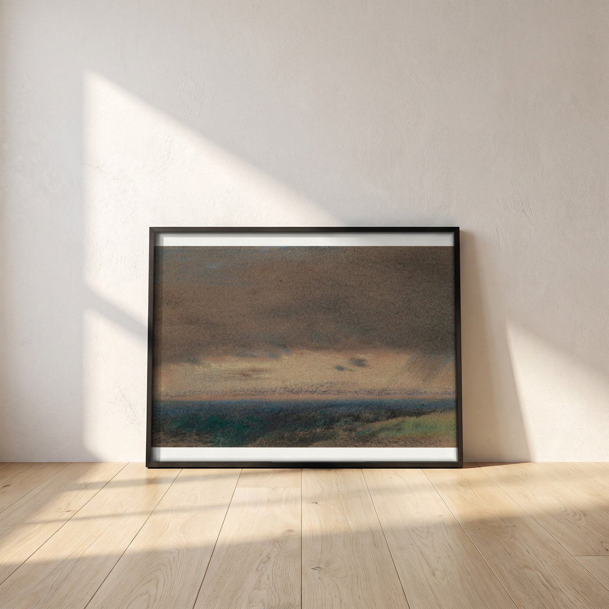 Stormy Clouds at Sunrise framed print in a black frame leaning against a white plaster wall on oak floorboards in morning light