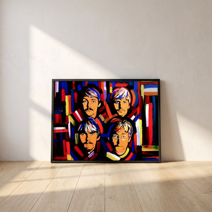 The Beatles Fab Four framed print in a black frame leaning against a white plaster wall on oak floorboards in morning light