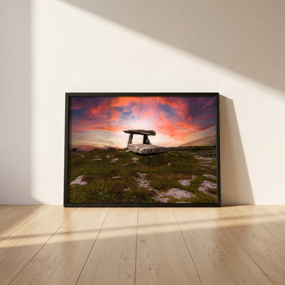 Poulnabrone Dolmen framed print in a black frame leaning against a white plaster wall on oak floorboards in morning light