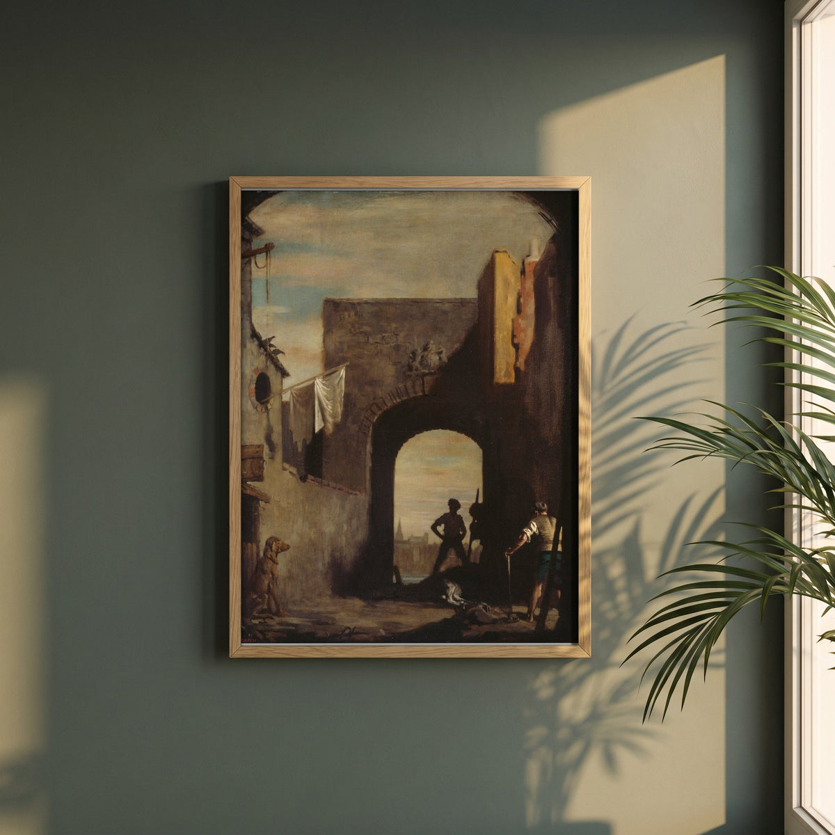 The Knacker's Yard framed print in a natural oak frame on a dark green wall beside a window, dappled plant shadow