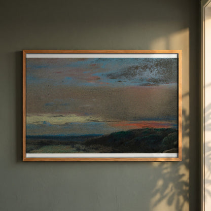 The Moor at Sunrise framed print in a natural oak frame on a dark green wall beside a window, dappled plant shadow