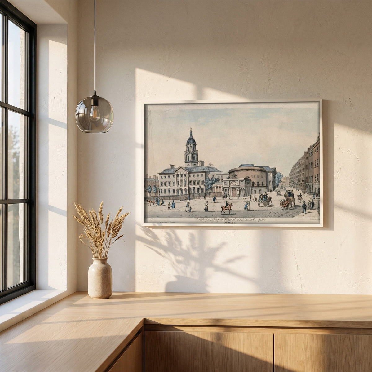 The Rotunda & Rutland Square, Dublin framed print in a white frame on a plaster wall above an oak worktop in a bright Scandinavian kitchen