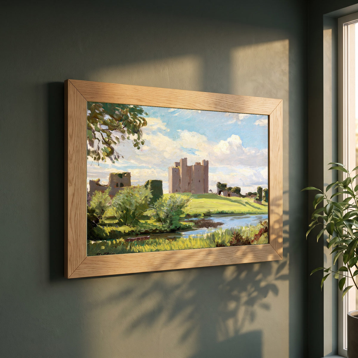 Trim Castle framed print in a natural oak frame on a dark green wall beside a window, dappled plant shadow
