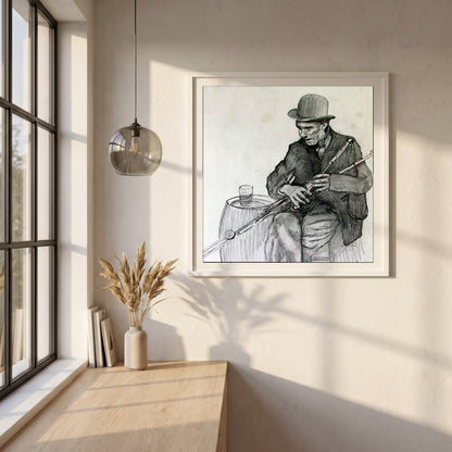 Uilleann Piper framed print in a white frame on a plaster wall above an oak worktop in a bright Scandinavian kitchen